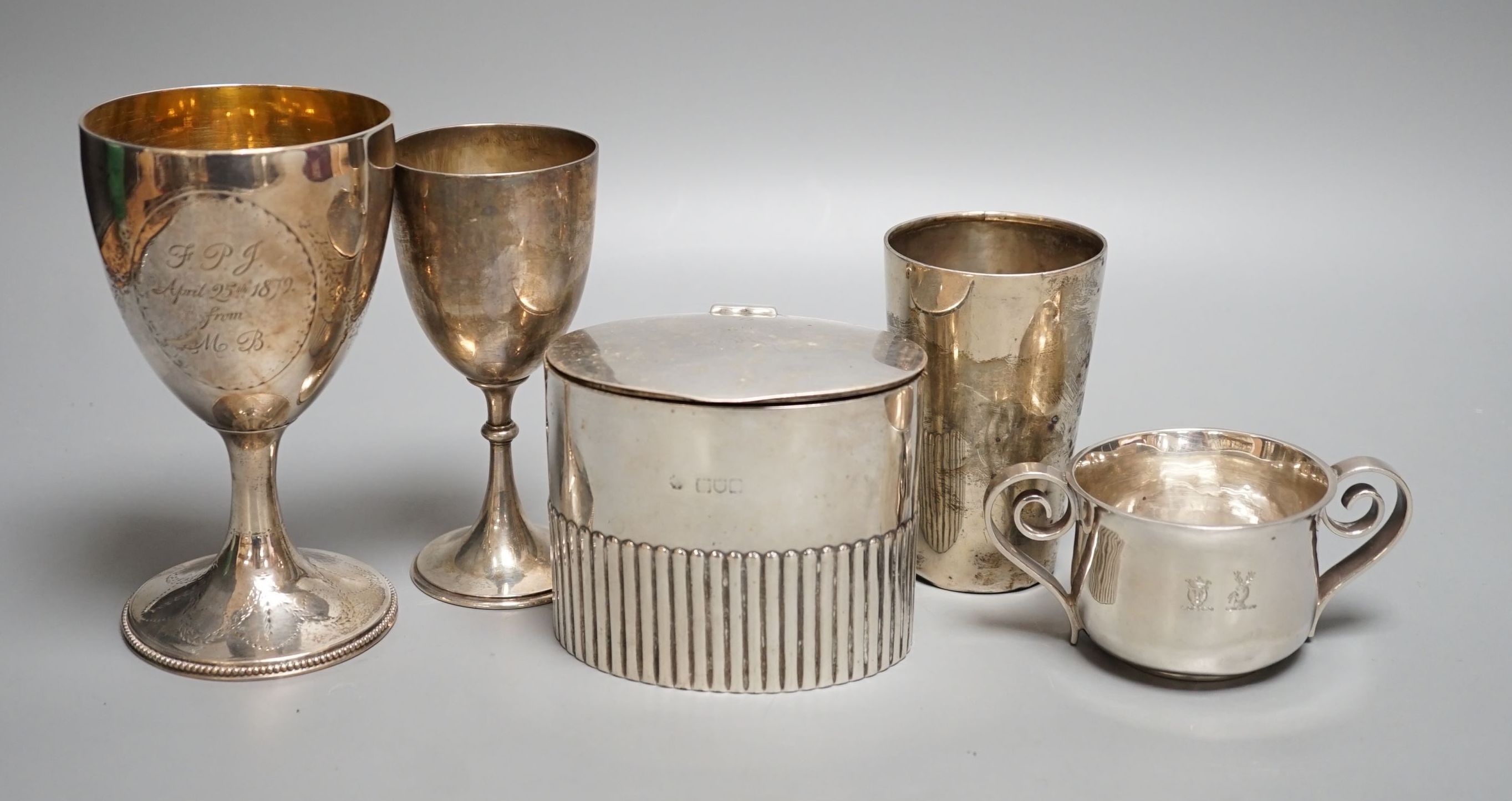 A George III engraved silver goblet, maker's mark rubbed, London, 1784, 14.6cm, together with an Edwardian silver tea caddy, a Victorian goblet, silver beaker and Brittania standard two-handle bowl by George Perkins, Lon